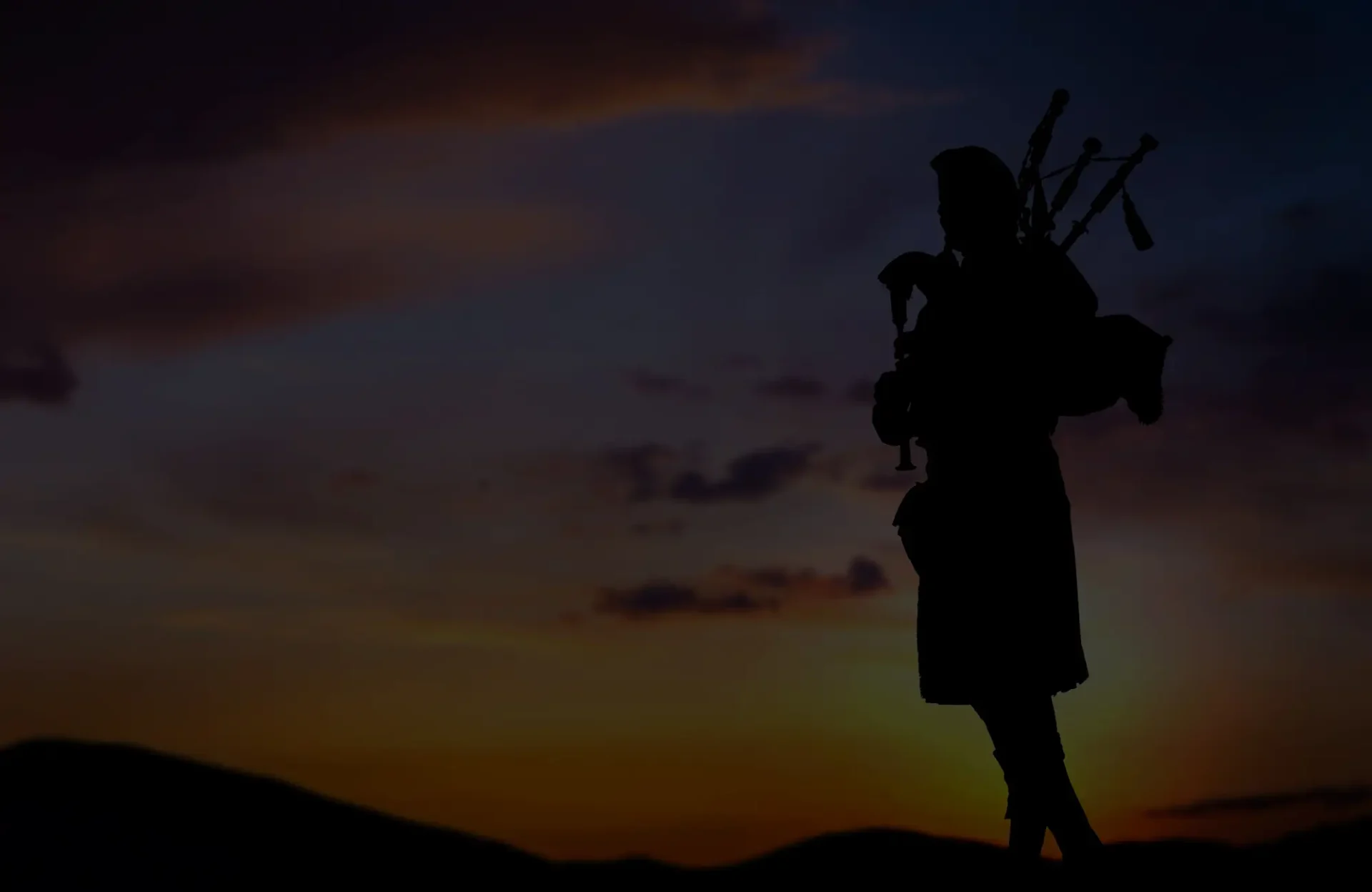 bagpiper at sunset